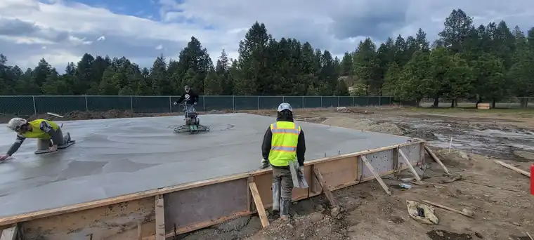A crew finishing a slab inside the forms