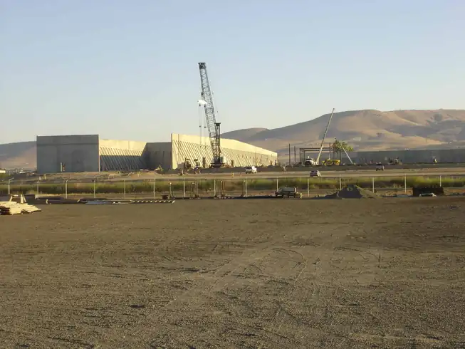 A crane on the Ace Hardware distribution center site in Moxee with tilt-up walls going up