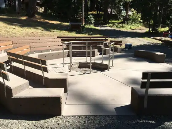 The octagonal colored concrete fire pit with bench seating at Camp Prime Time near White Pass