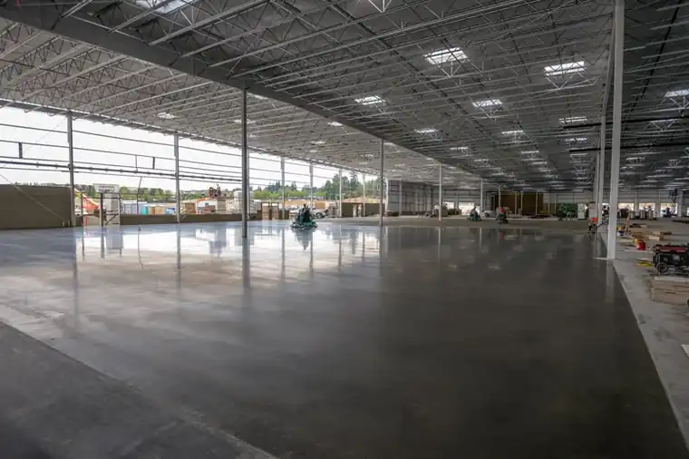 A finished Costco warehouse slab under the steel roof structure