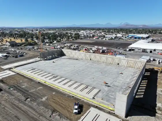 Aerial view of the finished tilt-up building for Project Jasper in Redmond, Oregon, with the Cascades behind
