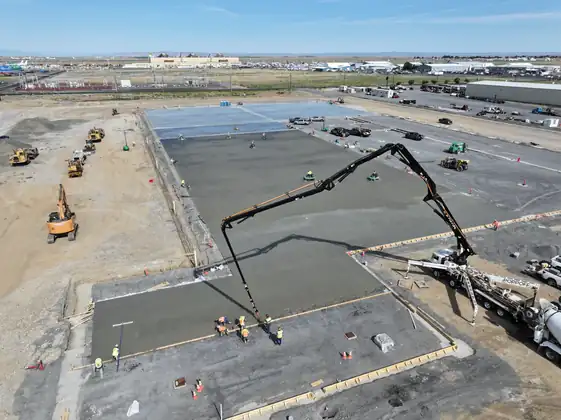 Aerial view of a boom pump placing a slab section at the LKQ Auto Parts site in Moses Lake