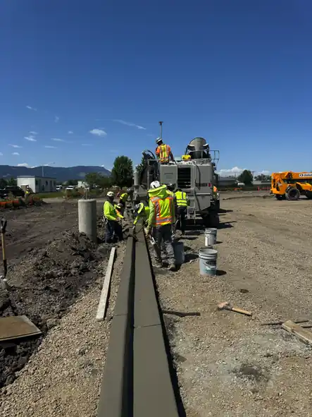Poppoff crew running the curb machine on the Project Nickle warehouse site in La Grande, Oregon