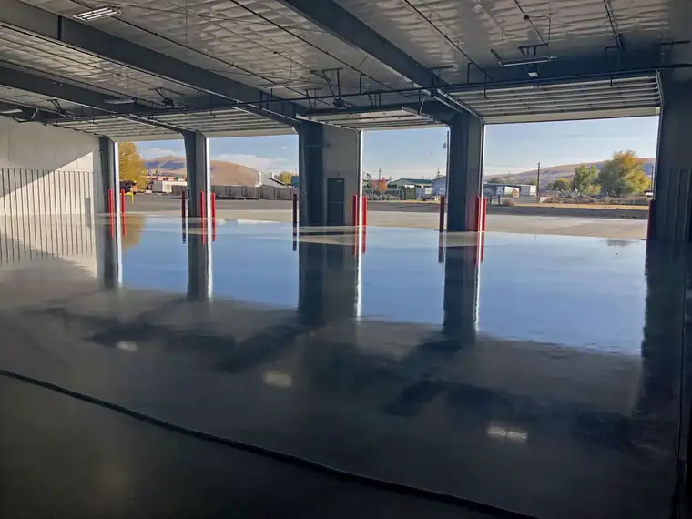 The jointless slab inside Poppoff's Moxee shop looking out through the roll-up door bays