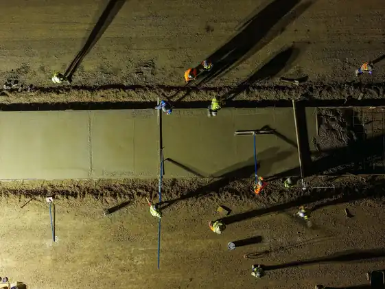 Top-down view of a Poppoff crew screeding a paving lane at the WinCo distribution site